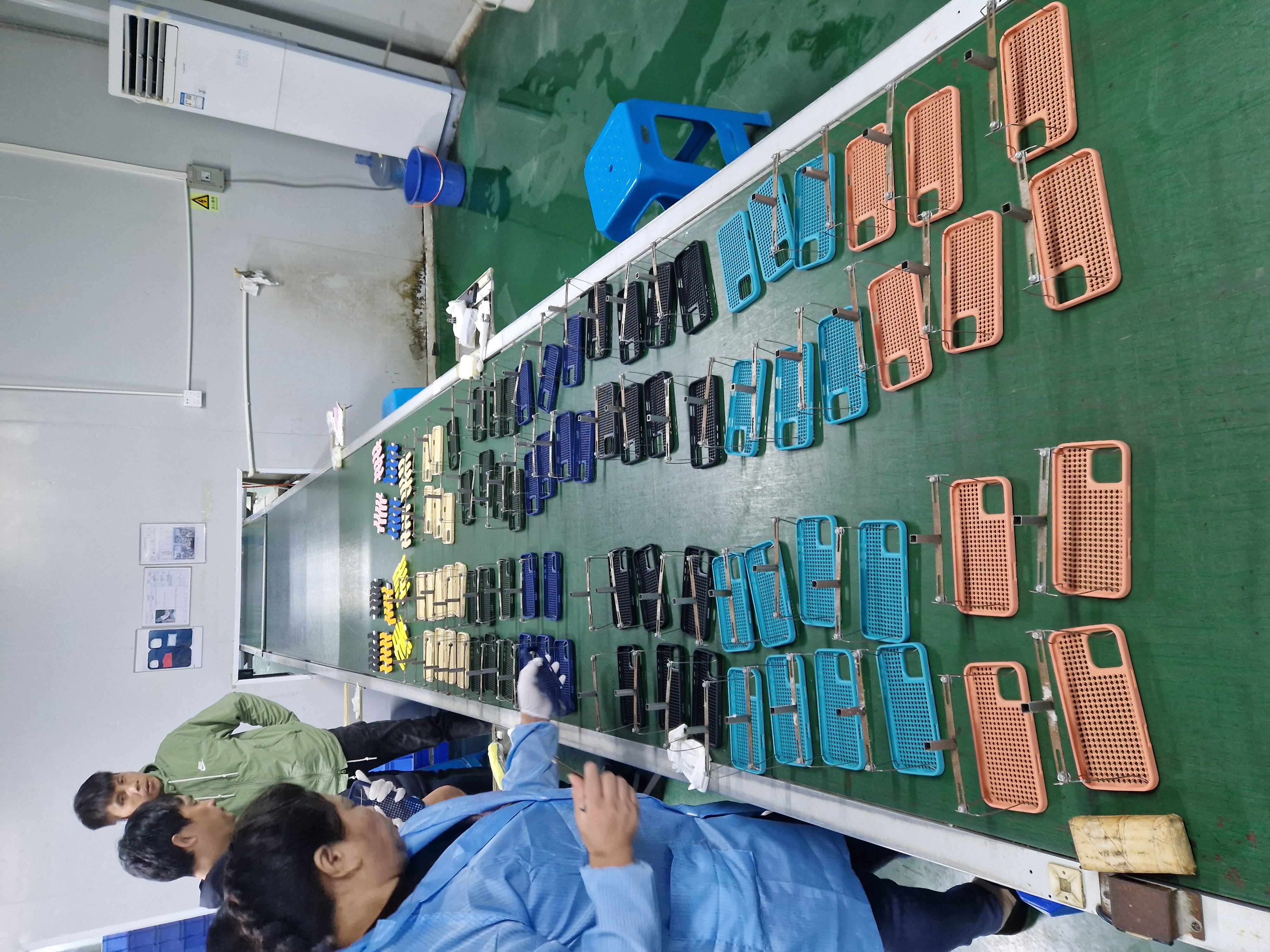 Production line with assembled plastic components during finishing and inspection.